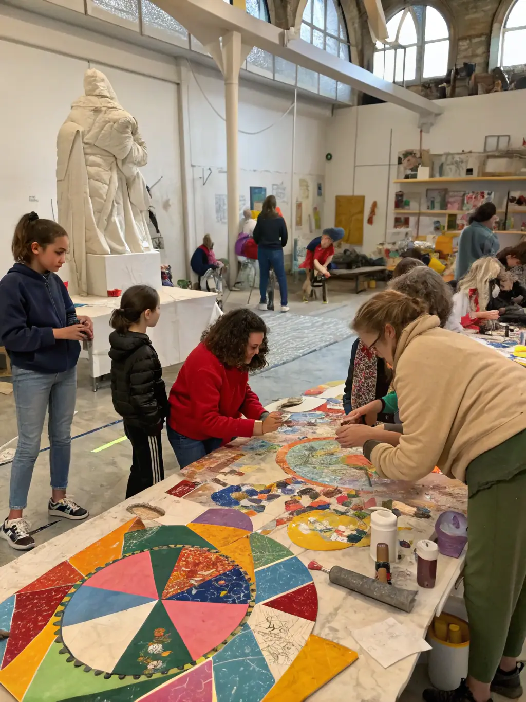 A group of diverse individuals actively participating in a stone carving workshop, focused on learning traditional techniques and creating their own sculptures, showcasing hands-on skill development.