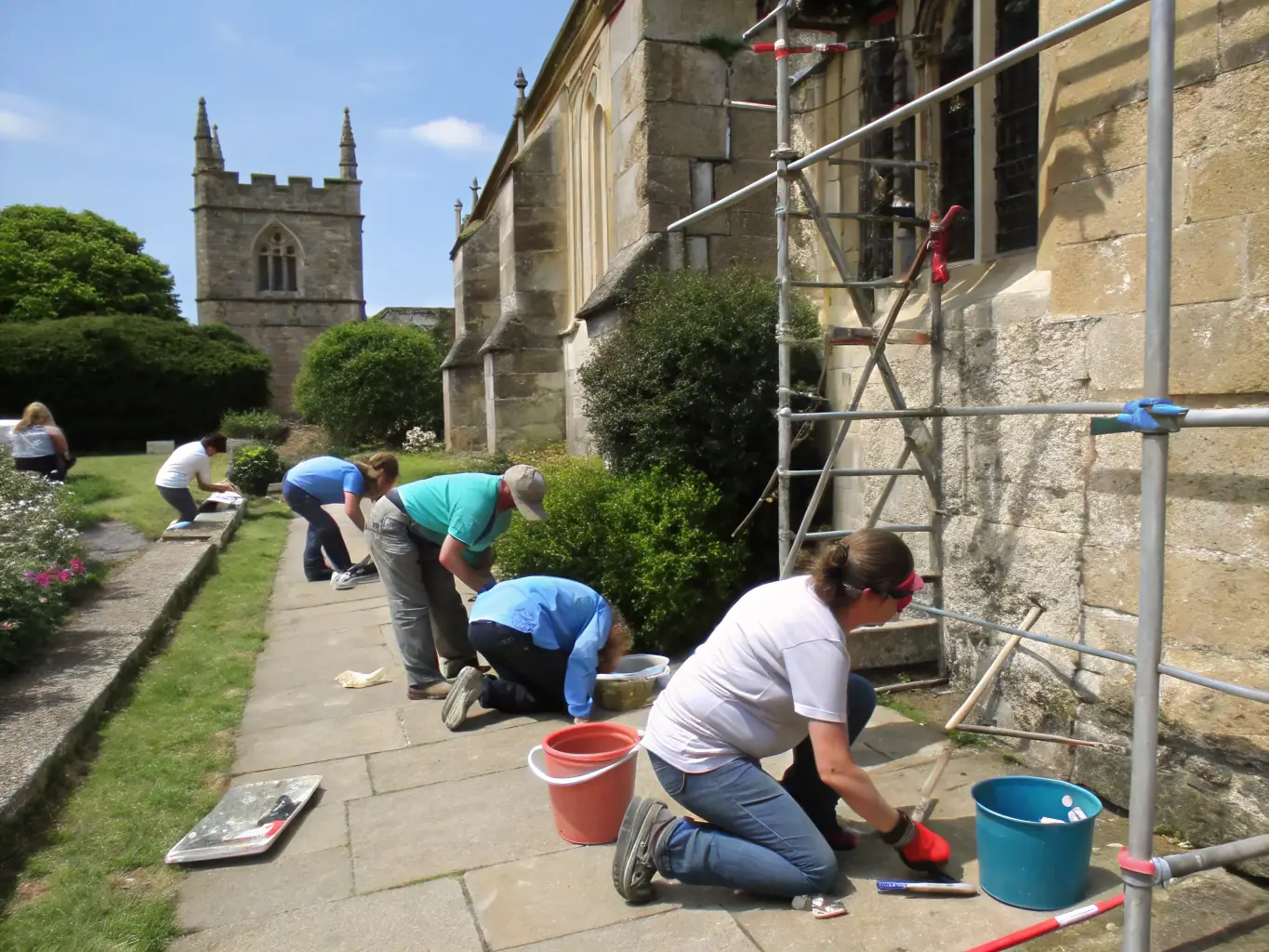 A serene image of volunteers working on the restoration of a historical site, carefully preserving stone structures and architectural details, with a focus on sustainable practices and community involvement.